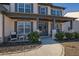 Covered front porch with seating and decorative planters at 5330 Austrian Pine Ct, Cumming, GA 30040