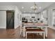 Modern kitchen with white cabinets, wood dining table and sliding barn door at 5330 Austrian Pine Ct, Cumming, GA 30040