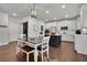 Modern kitchen with white cabinets, wood dining table and sliding barn door at 5330 Austrian Pine Ct, Cumming, GA 30040