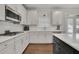 Modern kitchen with white cabinets, stainless steel appliances, and quartz countertops at 5330 Austrian Pine Ct, Cumming, GA 30040