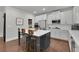 Modern kitchen with white cabinets, large island, and stainless steel appliances at 5330 Austrian Pine Ct, Cumming, GA 30040