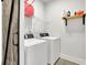 Laundry room with washer, dryer, and barn door at 5330 Austrian Pine Ct, Cumming, GA 30040