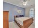 Spacious bedroom with wood sleigh bed and blue accent wall at 675 Jack Page Ln, Canton, GA 30115