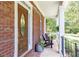 Brick entryway with a wooden door and porch seating at 675 Jack Page Ln, Canton, GA 30115