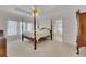 Spacious main bedroom with a large four-poster bed and access to a private deck at 675 Jack Page Ln, Canton, GA 30115