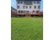 Spacious backyard featuring a large wooden deck, a green lawn, and mature landscaping at 2571 Sharondale Ne Dr, Atlanta, GA 30305