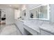 Bathroom boasts a marble-topped double vanity and white cabinets at 2571 Sharondale Ne Dr, Atlanta, GA 30305
