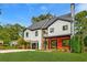Modern two-story home with white exterior, stone accents, and a three-car garage at 2571 Sharondale Ne Dr, Atlanta, GA 30305