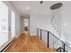 Elegant hallway with hardwood floors, modern light fixture, and access to deck and stairs at 2571 Sharondale Ne Dr, Atlanta, GA 30305