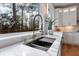 Kitchen sink with marble countertops and a gold gooseneck faucet at 2571 Sharondale Ne Dr, Atlanta, GA 30305