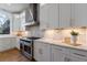 Modern kitchen with white cabinets, marble countertops, and stainless steel appliances at 2571 Sharondale Ne Dr, Atlanta, GA 30305