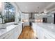 Bright kitchen features marble countertops, white cabinets, and hardwood floors at 2571 Sharondale Ne Dr, Atlanta, GA 30305