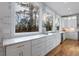 White kitchen with marble countertops, stainless steel appliances, and hardwood floors at 2571 Sharondale Ne Dr, Atlanta, GA 30305