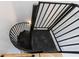 Modern black metal spiral staircase with safety gate at 2571 Sharondale Ne Dr, Atlanta, GA 30305