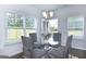 Bright dining area with glass table and four chairs, featuring large windows at 4268 Notting Hill Dr # 27, Atlanta, GA 30331