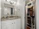 Bathroom with granite countertop, white cabinets and a walk-in closet at 5029 David Pl, Smyrna, GA 30082