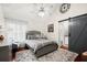 Main bedroom with gray bed frame and barn door at 5029 David Pl, Smyrna, GA 30082