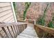 Wooden deck stairs leading down to a wooded area at 5029 David Pl, Smyrna, GA 30082