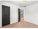 Simple bedroom with dark door and access to upstairs hall at 164 Goshen Ln, Woodstock, GA 30188