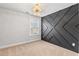 Spacious bedroom with a dark accent wall and a modern chandelier at 164 Goshen Ln, Woodstock, GA 30188