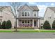 Gray two-story home with red chairs on front porch at 164A Goshen Ln, Woodstock, GA 30188