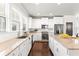 Modern kitchen with white cabinets, granite countertops, and stainless steel appliances at 164A Goshen Ln, Woodstock, GA 30188