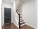 Modern staircase with dark wood railings and hardwood floors at 164A Goshen Ln, Woodstock, GA 30188