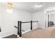 Upstairs hallway with neutral carpeting and a modern railing at 164A Goshen Ln, Woodstock, GA 30188