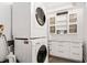 Functional laundry room equipped with a stacked washer/dryer and ample cabinet space at 170 Boulevard Se # E411, Atlanta, GA 30312