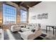 Spacious living room with an oversized sectional couch, rug, and vintage industrial windows at 170 Boulevard Se # E411, Atlanta, GA 30312