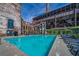 Beautiful pool with lounge chairs, green umbrellas, and historic building backdrop at 170 Boulevard Se # E411, Atlanta, GA 30312