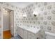 Bright bathroom with white vanity and floral wallpaper at 4750 Rebel Trl, Atlanta, GA 30327