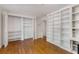 Bedroom with hardwood floors, built-in shelves and a closet at 4750 Rebel Trl, Atlanta, GA 30327