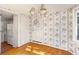 Small dining area with hardwood floors and floral wallpaper at 4750 Rebel Trl, Atlanta, GA 30327