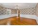 Bright dining room features hardwood floors, floral wallpaper, and a chandelier at 4750 Rebel Trl, Atlanta, GA 30327