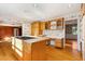 Sunny kitchen with island, wood cabinets, and hardwood floors at 4750 Rebel Trl, Atlanta, GA 30327