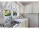 Laundry room with sink, washer, dryer, and white cabinets at 4750 Rebel Trl, Atlanta, GA 30327