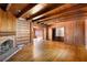 Living room with hardwood floors, wood paneling, built-ins and fireplace at 4750 Rebel Trl, Atlanta, GA 30327