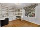 Home office with built-in shelving and hardwood floors at 4750 Rebel Trl, Atlanta, GA 30327