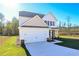 Two-story house with beige siding, stone accents, and a two-car garage at 48 Beaver Pt, Villa Rica, GA 30180