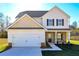 Two-story house with beige siding, stone accents, and a two-car garage at 48 Beaver Pt, Villa Rica, GA 30180