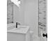 Clean bathroom with a single vanity, marble-look tile, and bathtub at 1273 Oakland Sw Ter, Atlanta, GA 30310