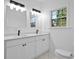 Bright bathroom with double vanity, marble-look tile, and modern fixtures at 1273 Oakland Sw Ter, Atlanta, GA 30310