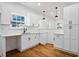 Modern kitchen with white cabinets, quartz countertops and black hardware at 1273 Oakland Sw Ter, Atlanta, GA 30310