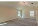 Bright bedroom with grey carpet and two windows at 204 Elm St, Palmetto, GA 30268