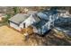 An elevated backyard view featuring a new deck, a white painted brick foundation and a fully fenced yard at 204 Elm St, Palmetto, GA 30268