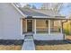 Charming front porch with black door and wood railing at 204 Elm St, Palmetto, GA 30268