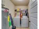 Functional laundry room with washer, dryer, and shelving at 4241 Caveat Ct, Fairburn, GA 30213