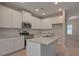 Modern kitchen with white cabinets, granite island, and stainless steel appliances at 16 Deer Place, Villa Rica, GA 30180