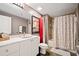 Bright bathroom with a white marble vanity, framed artwork, and a shower-tub combo with a decorative curtain at 170 Boulevard Se # H412, Atlanta, GA 30312